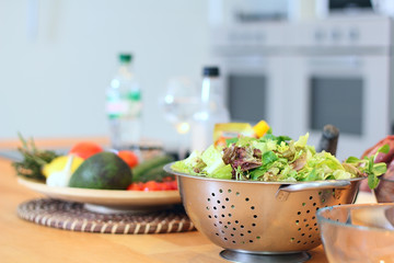 Green salad leaves are on a kitchen