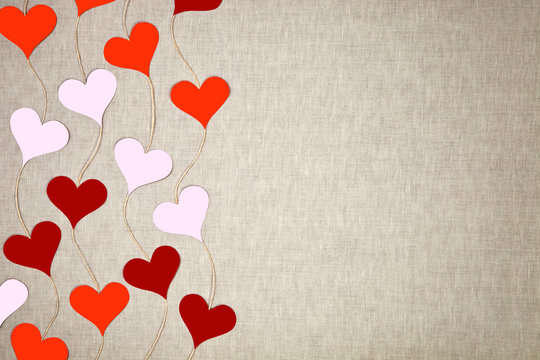 Hearts garlands on linen background