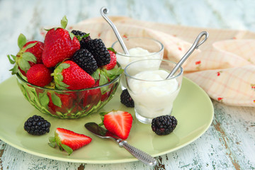 Yogurt with fresh berries in small glass