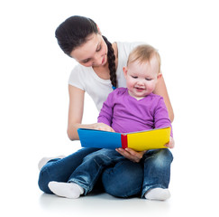happy mother reading a book to kid girl
