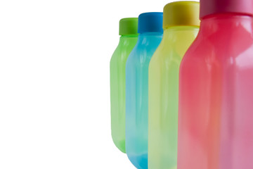 Colorful plastic water containers isolated on white