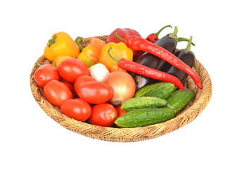 Vegetables in a wattled basket, isolated on white background
