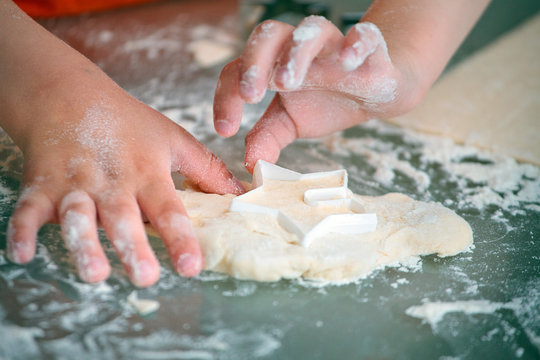 Close up of kid baking cookies