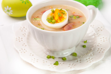 White borscht with eggs and white sausage.Polish easter soup