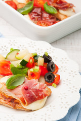 chicken fillet baked with mozzarella, Parma ham and vegetables