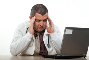 Hispanic american medical practitioner stressing on computer