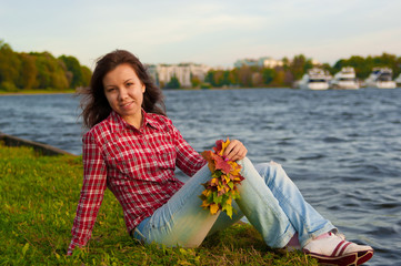 Girl sitting near river