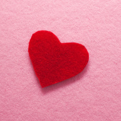 Fototapeta premium Felt red heart on pink background.