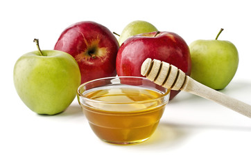 Red and green apples and a bowl of honey