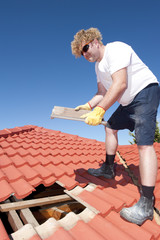 Construction worker tile roofing repairs