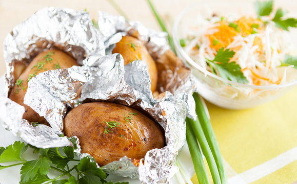 Jacket potatoes baked in foil, and greens