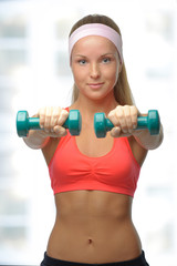 Image of blonde smiling woman with barbell in hand