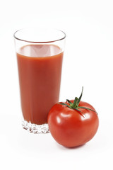 Tomato and juice in a glass on a white background