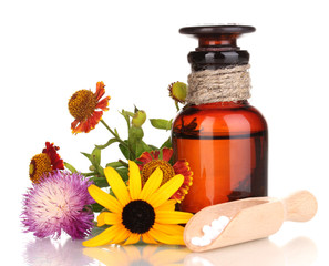 medicine bottle with tablets and flowers isolated on white