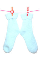 Pair of blue socks hanging on a rope isolated on white