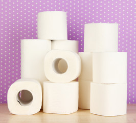 Rolls of toilet paper on purple with dots background