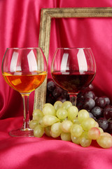 composition of frame,wine and grapes on bright background