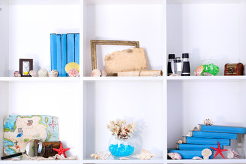 Beautiful white shelves with different travel related objects