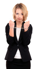 Young beautiful business woman in handcuffs isolated on white