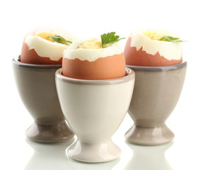Boiled eggs in egg cup, isolated on white