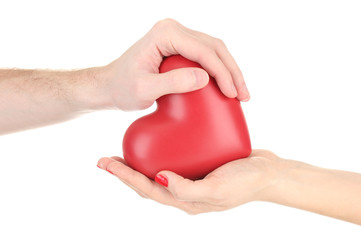 Red heart in woman and man hands, isolated on white