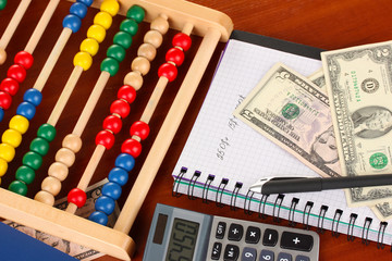 Bright wooden abacus and calculator. Conceptual photo of old