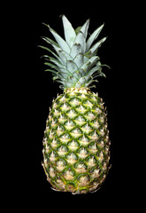 Fresh pineapple fruit with green leaves isolated on black