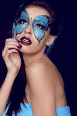 Naklejka premium Fashion woman Portrait. Butterfly makeup, face art make up