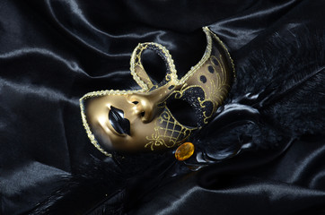 Gold carnival mask with black feathers