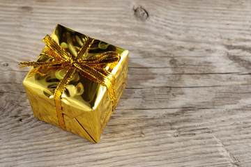 Golden gift box on wooden background