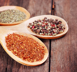 Various spices in wooden spoons close-up