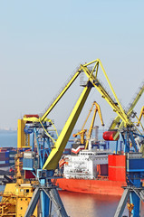 Container stack and ship under crane bridge