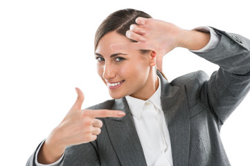 Portrait of beautiful business woman making frame gesture on whi