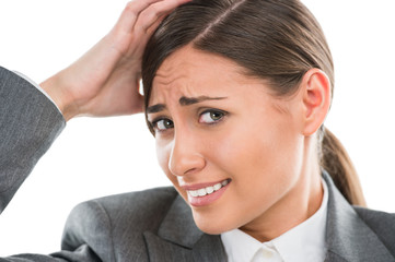 Portrait of shocked and confused business woman holding her head