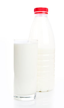 Glass of milk and bottle on white background