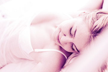Obraz na płótnie Canvas sexy blond woman sleep on bed in lingerie