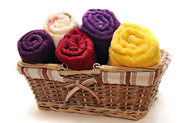 Obraz na płótnie Canvas Colorful towels in basket isolated on white
