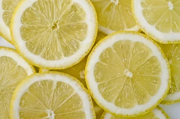 Tuinposter Voedselachtergrond - Gesneden mokken citroen © dmitrydesigner