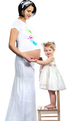 Pregnant mother with her sweet little baby girl isolated on whit