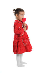 Girl in red dress holding a heart-shaped lollipop