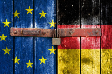 EU and Germany flag on the background of old locked doors