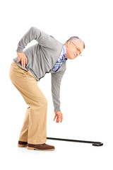 Full length portrait of a senior man with back pain trying to pi