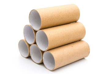 empty toilet rolls stack up on white