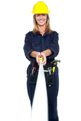 Engineer woman stretching measuring tape