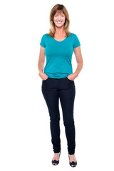 Casual trendy woman with hands in jeans pocket