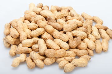 .Dried peanuts in closeup on the white background