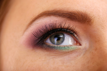 Fototapeta na wymiar Beautiful female eye with bright make-up, close up