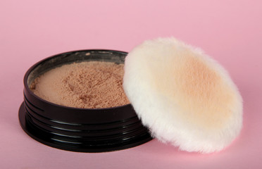 Powder and brush on pink background