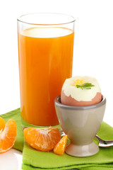 Light breakfast with boiled egg and glass of juice, isolated