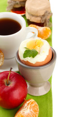 Light breakfast with boiled egg and cup of coffee, isolated